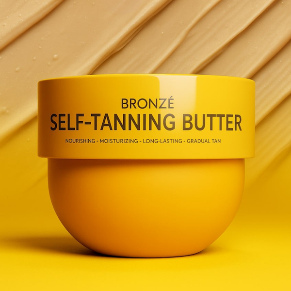 Bronzé Gradual Tanning Butter jar on a warm golden background